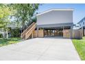 Open lower-level parking features an extra-large concrete pad, direct house access, and lush lawn at 13039 Keel Ct, Hudson, FL 34667