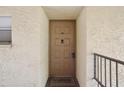 Close up of the front door to the condo, and 'Welcome to our home' mat at 14107 Mossy Glen Ln # 203, Tampa, FL 33613