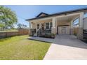 Inviting home featuring a covered front porch, lush lawn, and convenient carport at 1813 Hillside Dr, Tampa, FL 33610