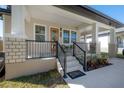 Welcoming front porch with stylish railing, comfortable seating, and decorative touches at 1813 Hillside Dr, Tampa, FL 33610