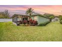 Expansive backyard featuring a screened lanai, mature landscaping, and ample green space at 1932 Sean Wood Cir, Brandon, FL 33510