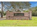 Community entrance sign for 'Woodberry,' featuring a brick facade and lush landscaping at 1932 Sean Wood Cir, Brandon, FL 33510