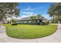 Well-maintained single-story home with lush green lawn and landscaping in a quiet neighborhood at 1932 Sean Wood Cir, Brandon, FL 33510