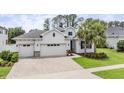Charming home featuring a three-car garage, well-manicured lawn, and tropical palm trees adding curb appeal at 19608 Lonesome Pine Dr, Land O Lakes, FL 34638