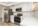 Modern kitchen showcasing stainless steel appliances, white cabinetry, and durable countertops at 2146 Waterside Dr, Clearwater, FL 33764