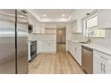 Bright kitchen featuring white cabinets, stainless steel appliances, and quartz countertops at 2146 Waterside Dr, Clearwater, FL 33764