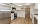 Renovated kitchen with white cabinets, stainless steel appliances, and new flooring at 2146 Waterside Dr, Clearwater, FL 33764
