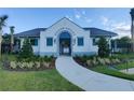 Community clubhouse featuring elegant details, like turquoise shutters and lush landscaping at 23300 Willow Glen Way, Lutz, FL 33549