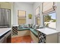 Cozy breakfast nook with a corner bench, wine rack, and natural lighting at 241 72Nd N St, St Petersburg, FL 33710