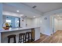 Modern kitchen features sleek countertops, stylish bar stool seating, recessed lighting, and open design at 2870 Rampart Cir, Clearwater, FL 33761