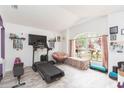Comfortable living room with plenty of natural light, a large window and a treadmill for exercise at 34447 Blue Ash Ct, Wesley Chapel, FL 33545