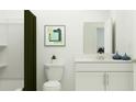 A minimalist bathroom features a white vanity and a shower with a green curtain at 3465 Lapis Lake Dr, Zephyrhills, FL 33541