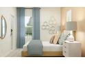 An inviting bedroom with a comfortable bed, stylish decor, window views, and honey-comb wall art at 3481 Lapis Lake Dr, Zephyrhills, FL 33541