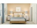 A cozy bedroom with a wooden bed frame, matching nightstands, bee themed decor and soft lighting at 3481 Lapis Lake Dr, Zephyrhills, FL 33541