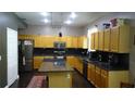 Spacious kitchen with an island, dark granite countertops, and ample cabinet space at 3914 Roswell Pl, Land O Lakes, FL 34639