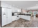 Bright kitchen features white cabinets, granite counters, and stainless appliances at 399 2Nd St # 217, Indian Rocks Beach, FL 33785