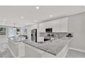 Open-concept kitchen featuring white cabinetry, granite countertops, stainless steel appliances at 4071 45Th N Ave, St Petersburg, FL 33714