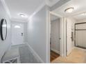 Condo entryway featuring a bench, hallway, and doorway view to bathroom at 4103 Gulf Blvd # 107, St Pete Beach, FL 33706