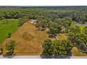 Expansive aerial view of a large parcel of land with lush trees and open fields at 495 Appaloosa Rd, Tarpon Springs, FL 34688