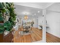 Bright dining room with hardwood floors, modern chandelier, and open access to the kitchen at 5707 N Branch Ave, Tampa, FL 33604