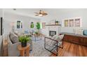Cozy living room featuring hardwood floors, a decorative fireplace, and an abundance of natural light at 5707 N Branch Ave, Tampa, FL 33604