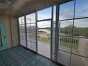 Enclosed balcony with tile flooring offering serene views of the outdoors at 6315 Shoreline Dr # 3107, St Petersburg, FL 33708