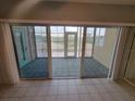 Enclosed balcony with tile flooring offering serene views of the outdoors at 6315 Shoreline Dr # 3107, St Petersburg, FL 33708