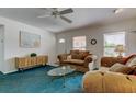 Comfortable living room with ceiling fan and natural light from bright windows at 6421 Wilshire Dr, Tampa, FL 33615