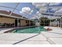 Refreshing screened-in pool area, perfect for relaxation and outdoor entertainment at 6421 Wilshire Dr, Tampa, FL 33615