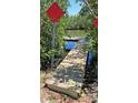 Wooden walkway leading to a calm and beautiful lake and dock at 6903 11Th Ave E, Palmetto, FL 34221