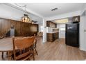 Cozy kitchen and dining area featuring wood cabinets, laminate floors, and ample natural light at 7020 Sonata Dr, Port Richey, FL 34668
