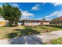 View of the front of the home and partial yard at 7075 Sunset S Dr, South Pasadena, FL 33707