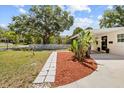 Well-maintained front yard with lush landscaping and charming white picket fence at 708 53Rd N Ave, St Petersburg, FL 33703
