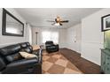 Cozy living room with leather seating, a ceiling fan, and hardwood floors at 731 20Th Nw St, Largo, FL 33770