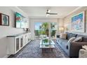 Comfortable living room featuring stylish decor, a cozy couch, and access to a scenic balcony at 7564 Bayshore Dr # 302, Treasure Island, FL 33706