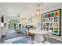 Inviting living space with modern furnishings, artistic decor, and a bright dining area for entertaining at 7564 Bayshore Dr # 302, Treasure Island, FL 33706