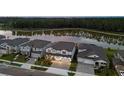 Stunning aerial view of homes near a serene lake, surrounded by lush green trees at 7819 Notched Pine Bnd, Wesley Chapel, FL 33545