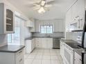 Bright kitchen featuring white cabinetry, stainless steel appliances, tile backsplash, and tile flooring at 904 Desert Hills Dr, Sun City Center, FL 33573