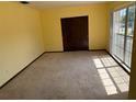 Bright bedroom with natural light from large window and large closet with sliding doors at 531 Carriage Hills Dr, Temple Terrace, FL 33617