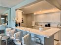 Bright kitchen bar featuring white cabinets and a modern, marble-look countertop with seating at 100 Bluff View Dr # 105C, Belleair Bluffs, FL 33770