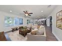Bright living room with hardwood floors and open access to the kitchen and dining area at 10922 Park Dr, Riverview, FL 33569