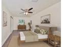 Comfortable main bedroom features modern ceiling fan, light walls, and wood-look flooring at 10922 Park Dr, Riverview, FL 33569
