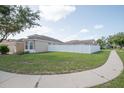 Spacious yard with a white picket fence, offering privacy and security for outdoor enjoyment at 11021 Silver Dancer Dr, Riverview, FL 33579