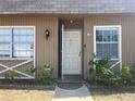 Charming townhouse featuring a welcoming front door and decorative window details at 11511 113Th St # 5C, Largo, FL 33778
