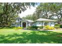 Charming single-Gathering home with a well-manicured lawn and mature trees at 12002 Hope Ln, Tampa, FL 33618