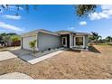 Well-maintained single-story home with a two-car garage, small garden, and a front lawn at 12119 Buffington Ln, Riverview, FL 33579