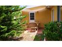 Cozy outdoor patio featuring comfortable wicker furniture, perfect for relaxing and entertaining in the garden at 12407 Partridge Hill Row, Hudson, FL 34667