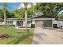 Beautiful home boasts an attached two car garage, manicured lawn, and lovely landscaping at 1332 Marjohn Ave, Clearwater, FL 33756