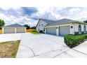 Spacious driveway and two-car garage with detached two-car garage and neutral paint at 13338 Jaudon Ranch Rd, Dover, FL 33527