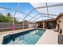 Inviting screened-in pool with ample seating and sunbathing space, perfect for relaxation and outdoor entertaining at 1447 Stetson Dr, Wesley Chapel, FL 33543